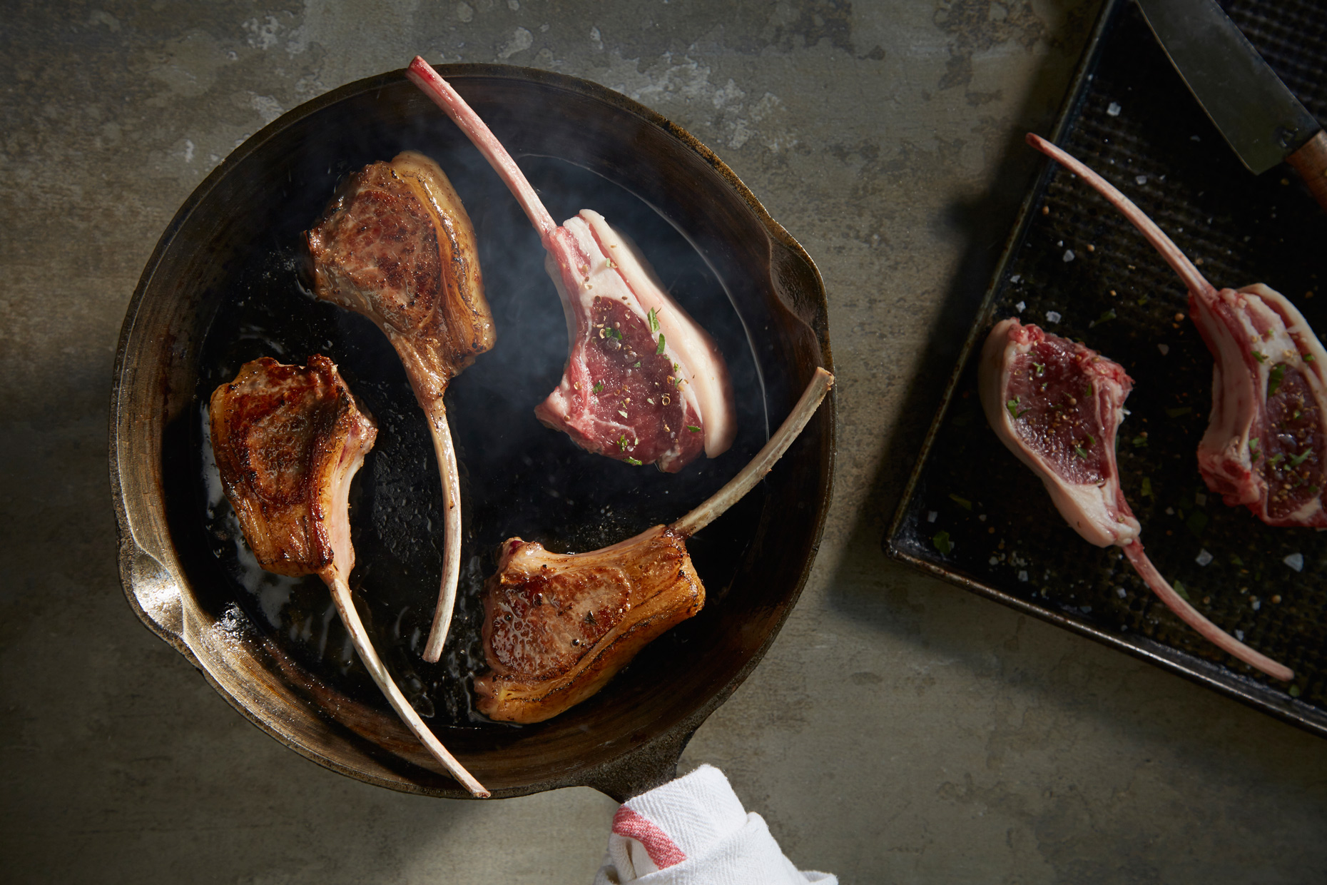 Lamb Chops in Cast Iron Skillet photo by Chris Kessler Photography. Sliced meat. Chris Kessler is a freelance Photographer based in Milwaukee Wisconsin. Specializing in Food photography and portraiture.