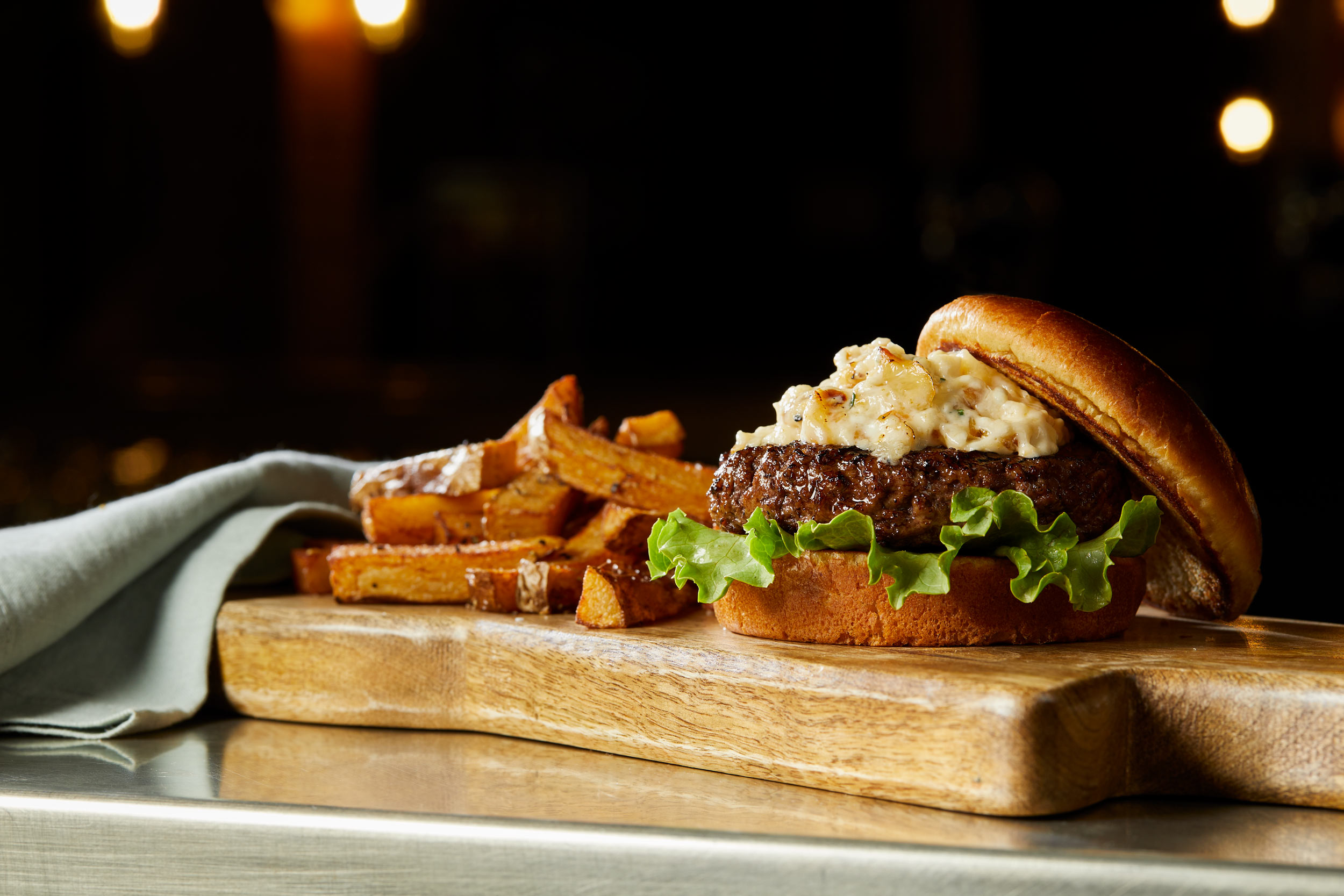 Burger with caramelized onions photo by Chris Kessler Photography.  Chris Kessler is a freelance Photographer based in Milwaukee Wisconsin. Specializing in Food photography and portraiture.